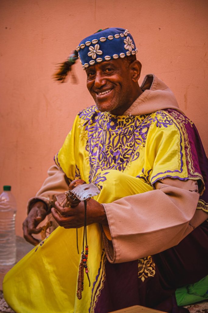 Moroccan man smiling and playing music